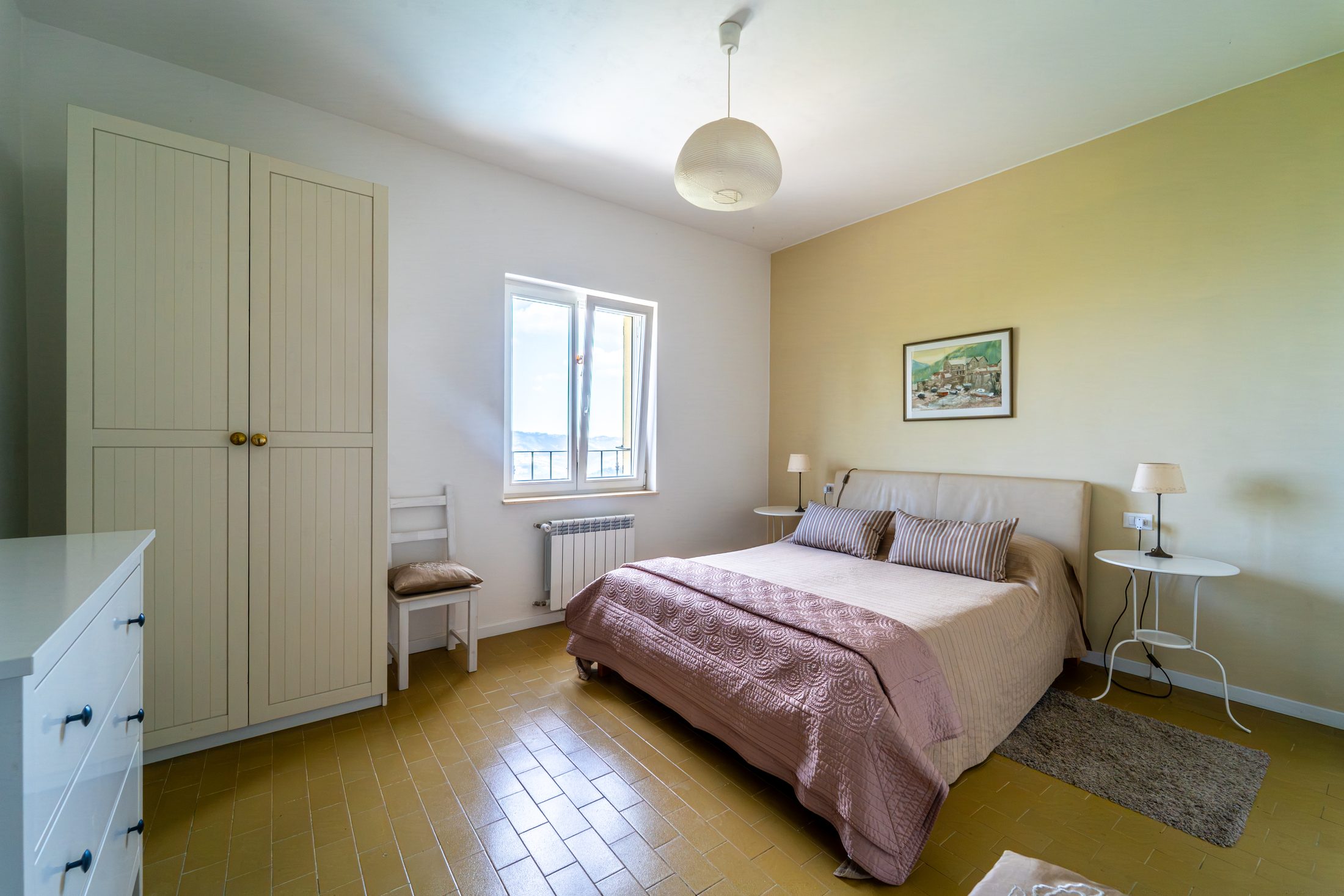 Apartment bedroom with yellow feature wall