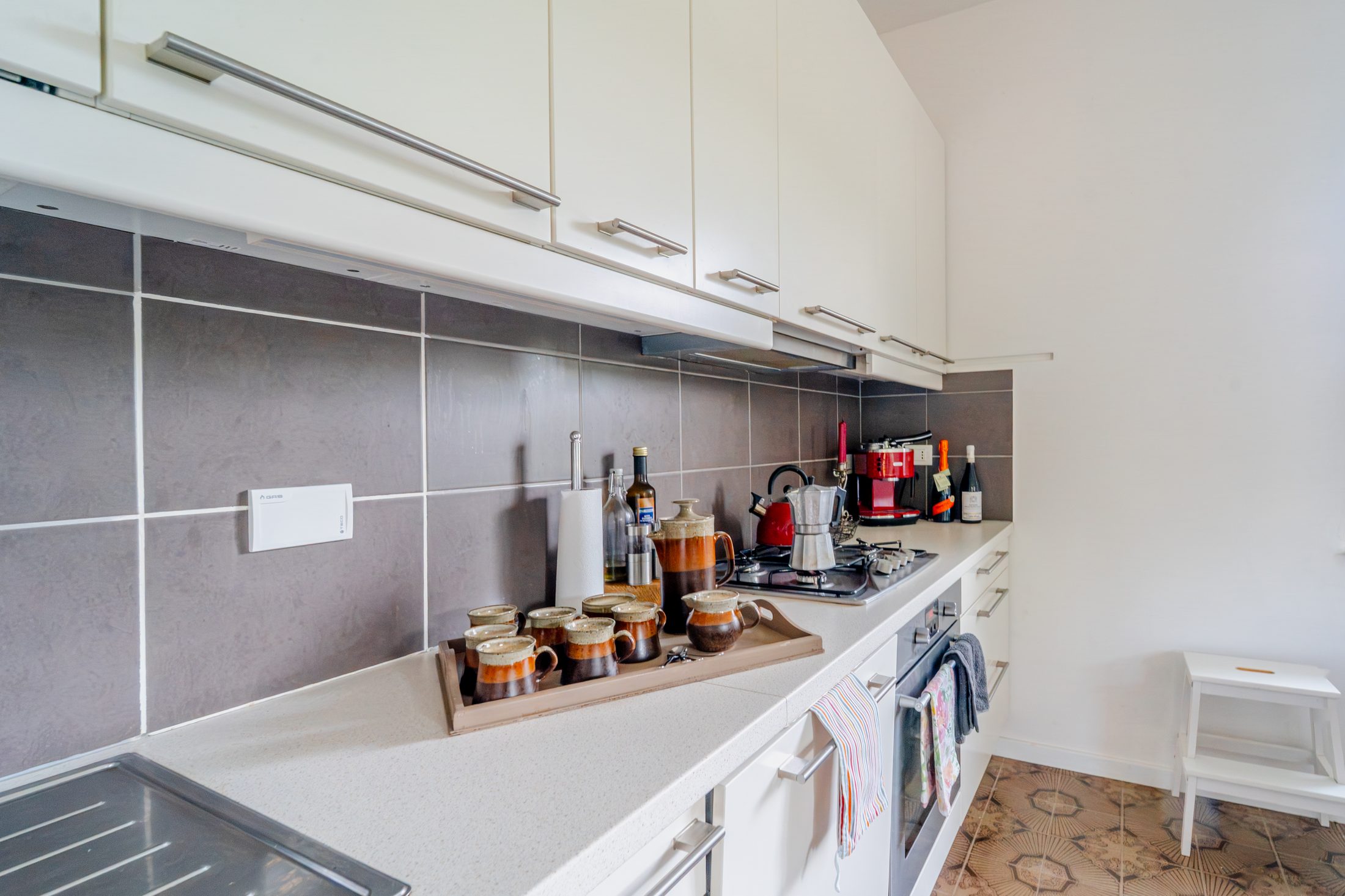 Kitchen counter with ceramic mugs and coffee station