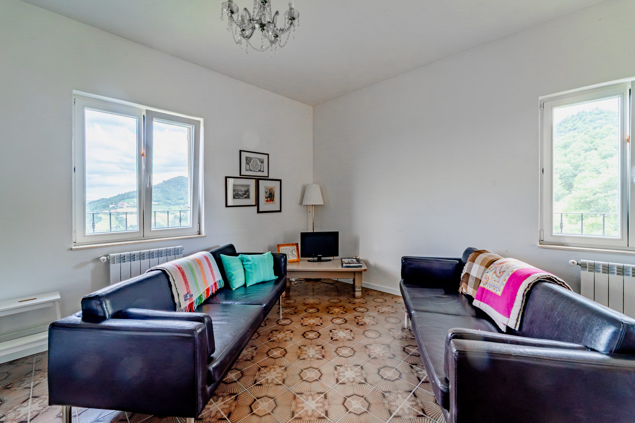 Living area with sofas, TV and valley-view windows