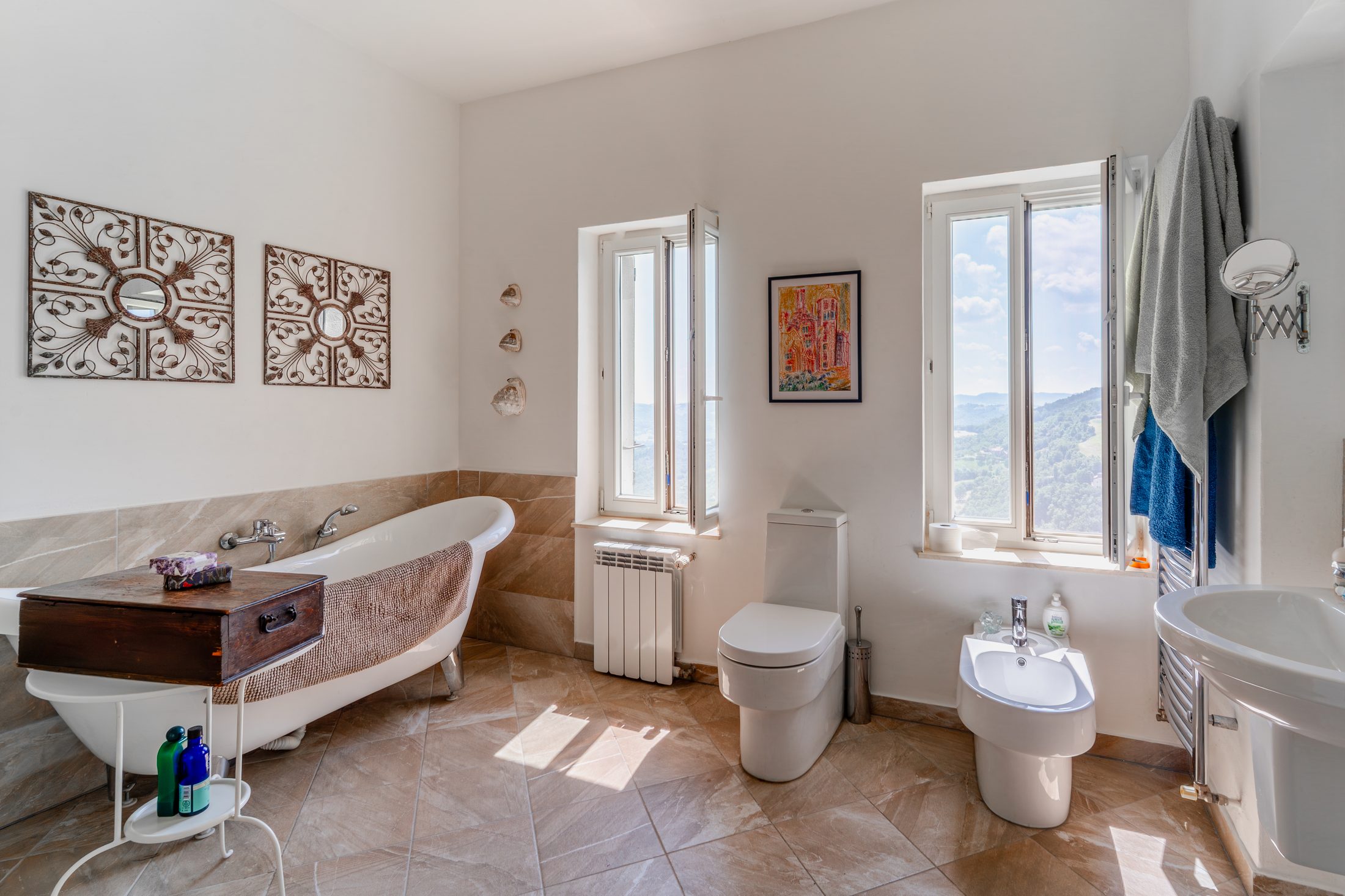 Family bathroom with roll-top bath and valley views