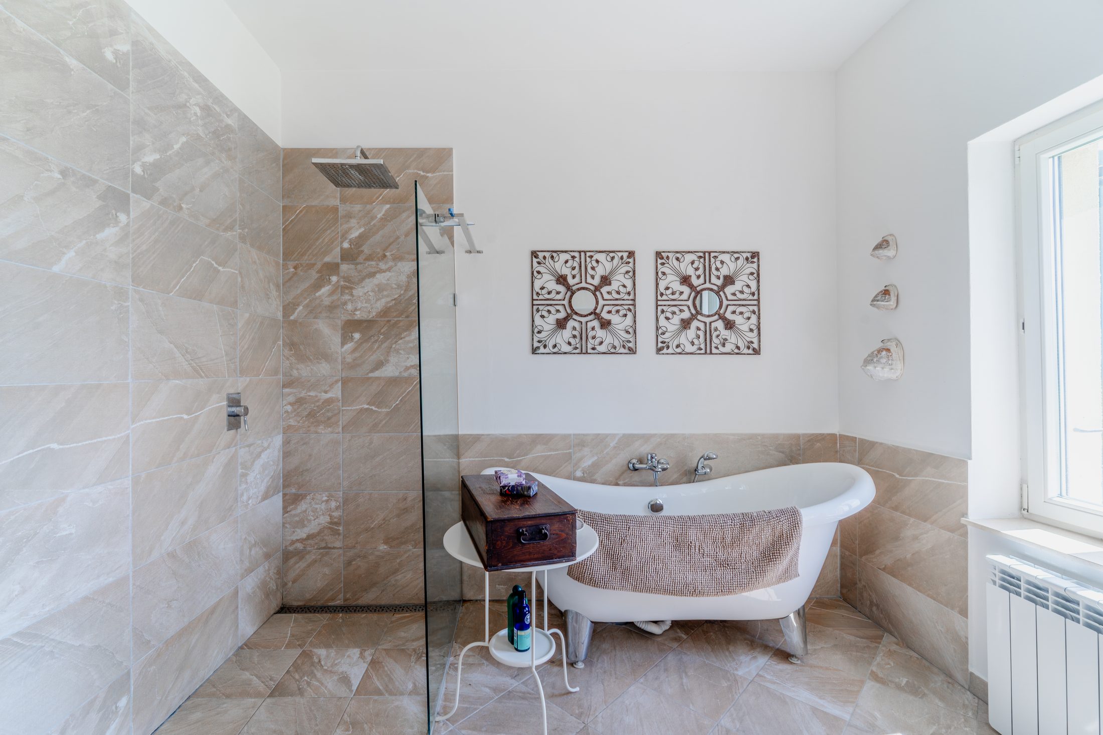 Family bathroom shower area and decorative wall mirrors