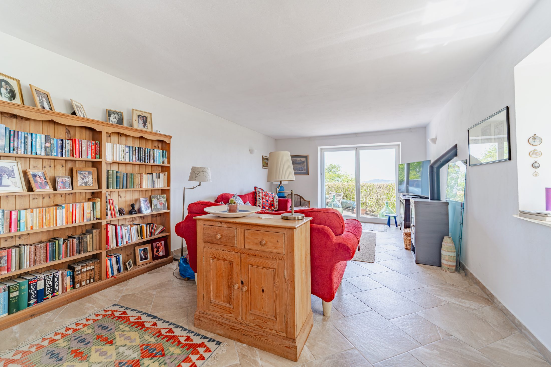 Bookshelves and sofas around the wood burner