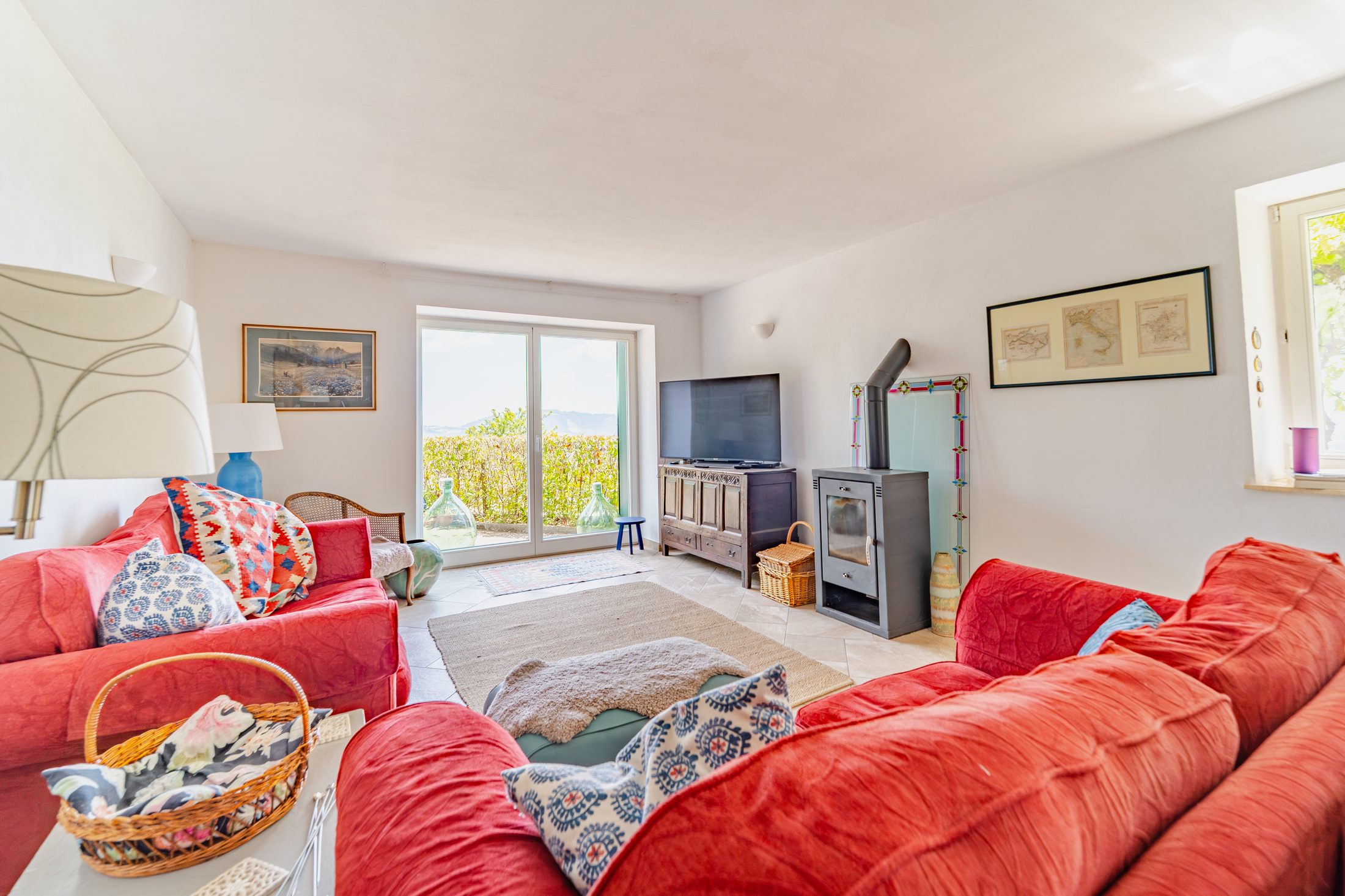 Sitting room with wood burner and doors to the terrace
