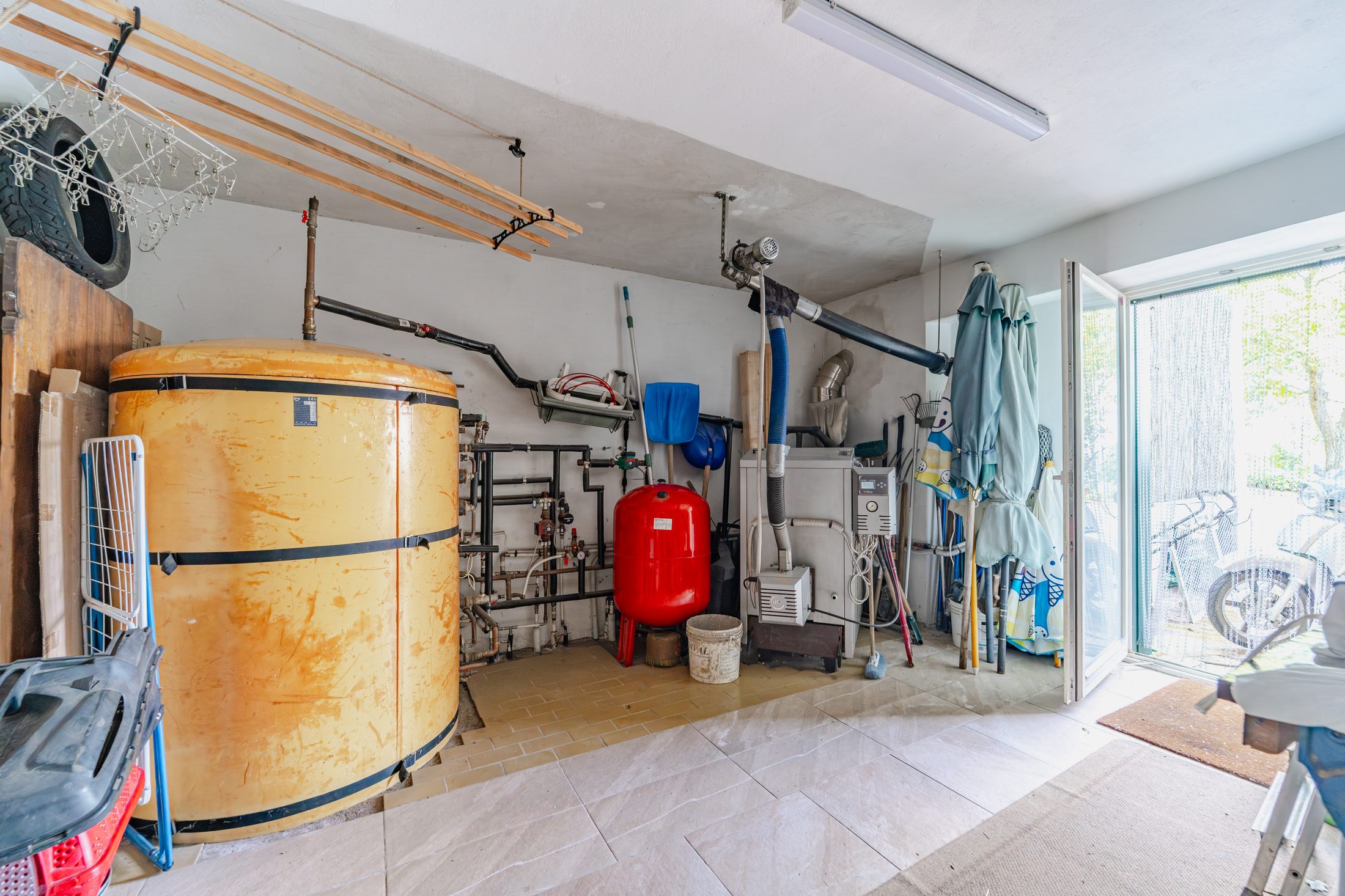 Boiler room with pellet boiler, hot water tank and storage