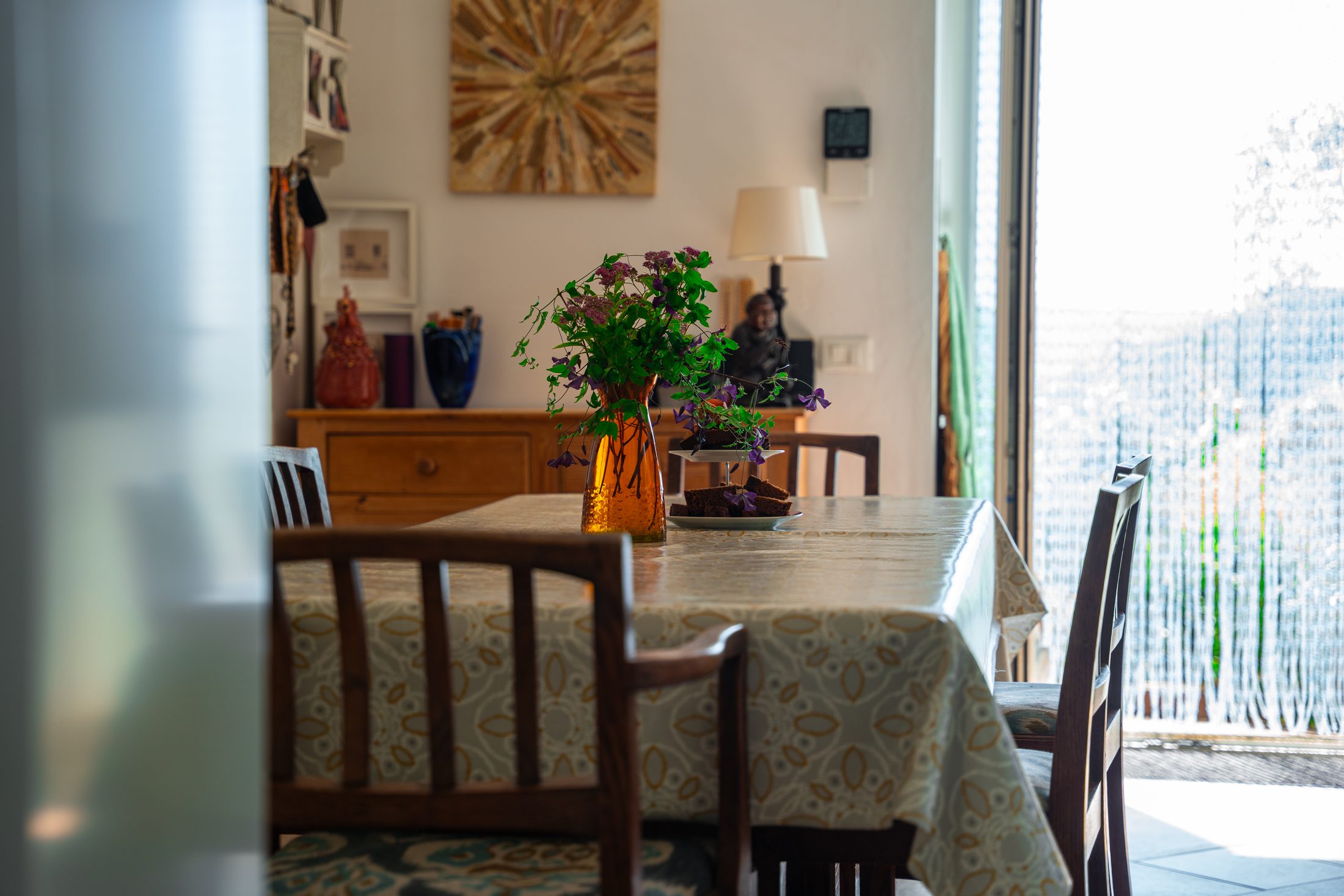 Dining table with flowers, doors open to the garden